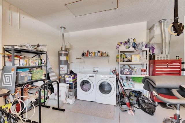 laundry room featuring water heater, a textured ceiling, and washer and clothes dryer