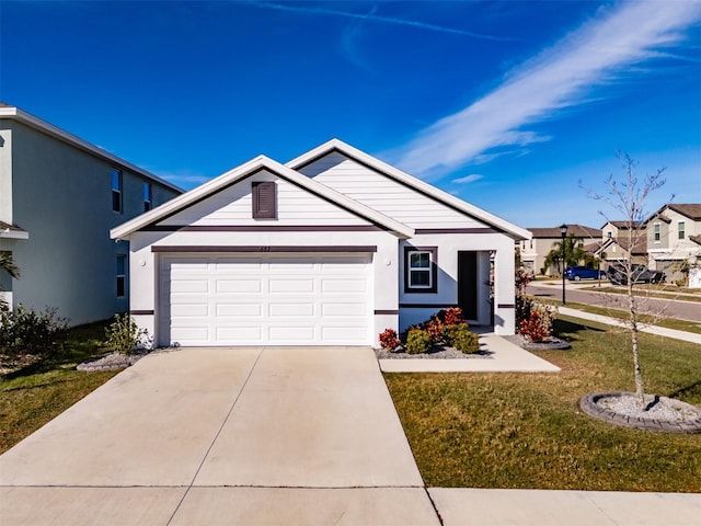 view of front of home with a garage and a front yard