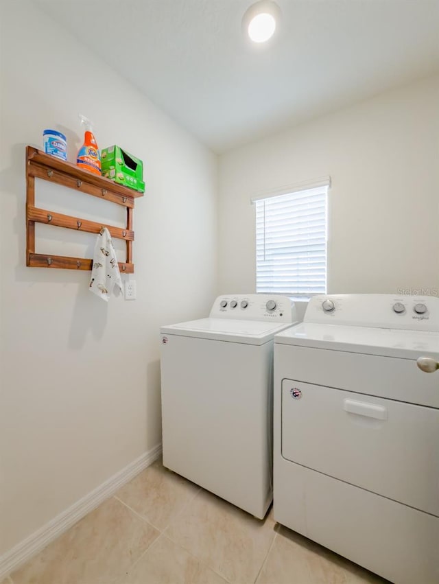 laundry area featuring washer and dryer and light tile patterned floors