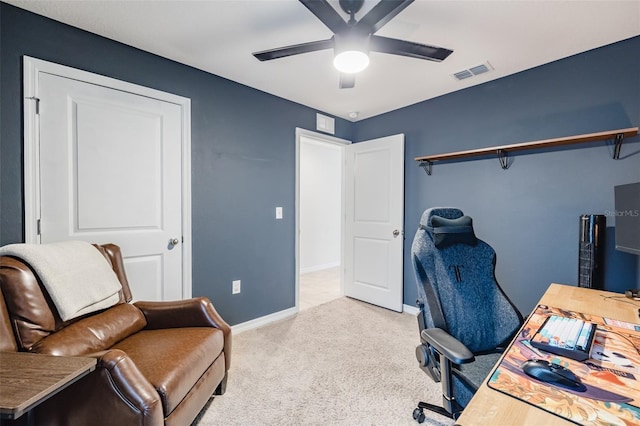 carpeted office space featuring ceiling fan