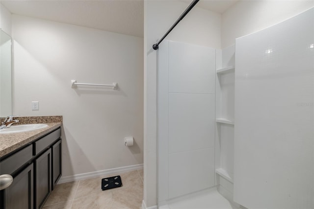 bathroom featuring walk in shower, vanity, and tile patterned flooring