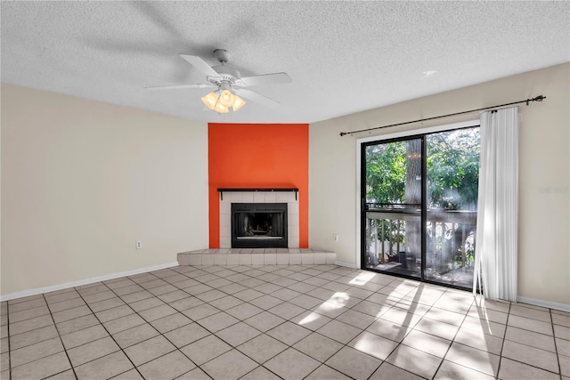 unfurnished living room featuring ceiling fan, a textured ceiling, and a fireplace