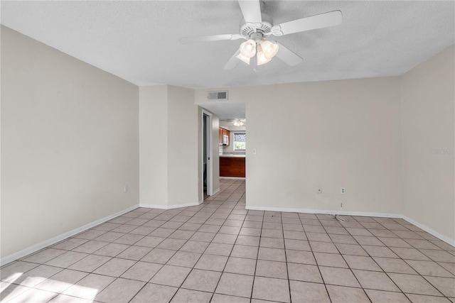 empty room featuring ceiling fan and a textured ceiling