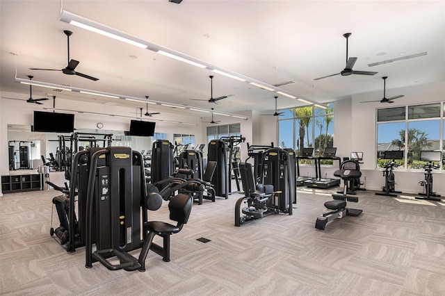 gym featuring light carpet and ceiling fan