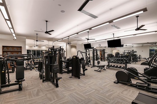 workout area featuring light colored carpet and ceiling fan