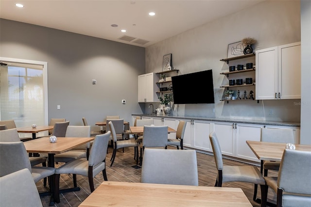 dining space with wood-type flooring