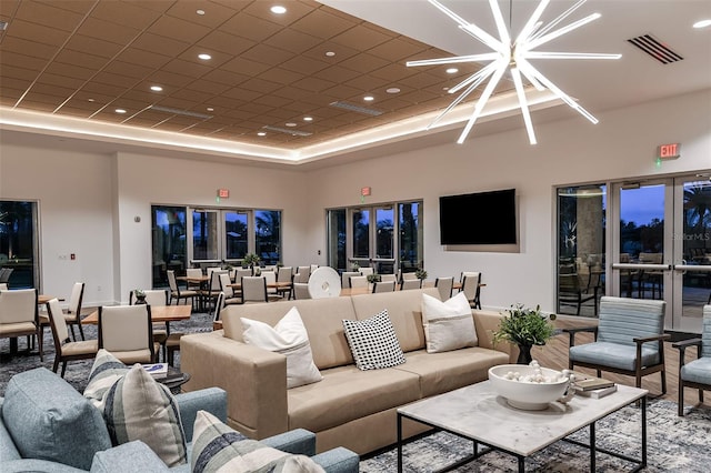 living room with a towering ceiling and an inviting chandelier