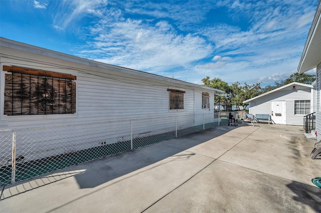 view of property exterior with a patio