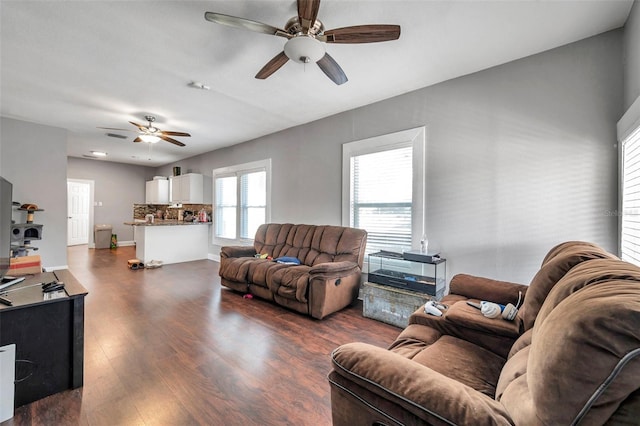 living room with ceiling fan and dark hardwood / wood-style flooring