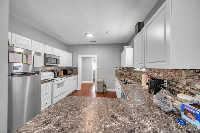 kitchen featuring white cabinetry, sink, decorative backsplash, and stainless steel appliances