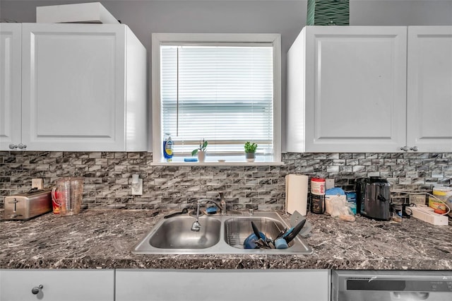 kitchen with white cabinetry, sink, decorative backsplash, and stainless steel dishwasher