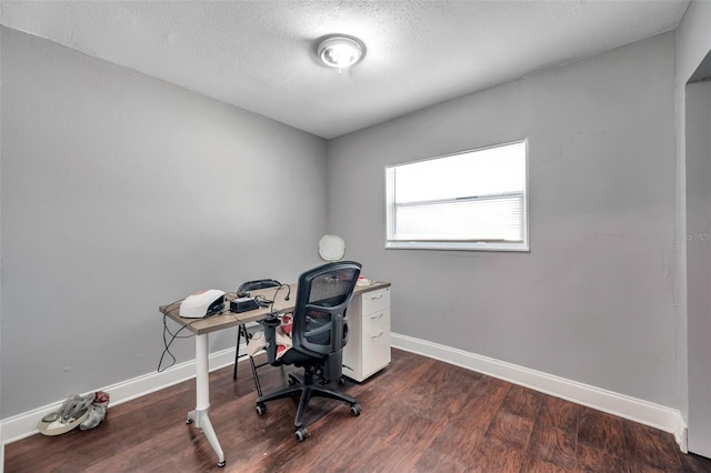 office area with dark wood-type flooring and a textured ceiling