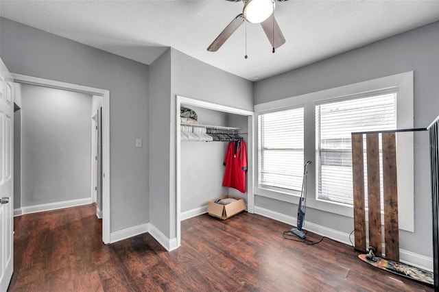 unfurnished bedroom featuring dark hardwood / wood-style floors, ceiling fan, and a closet