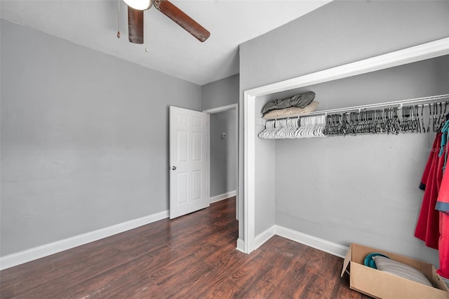 unfurnished bedroom with dark hardwood / wood-style flooring, ceiling fan, and a closet