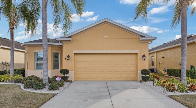 ranch-style home featuring cooling unit and a garage