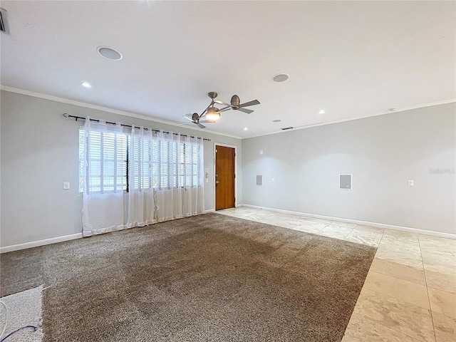 carpeted spare room featuring crown molding and ceiling fan