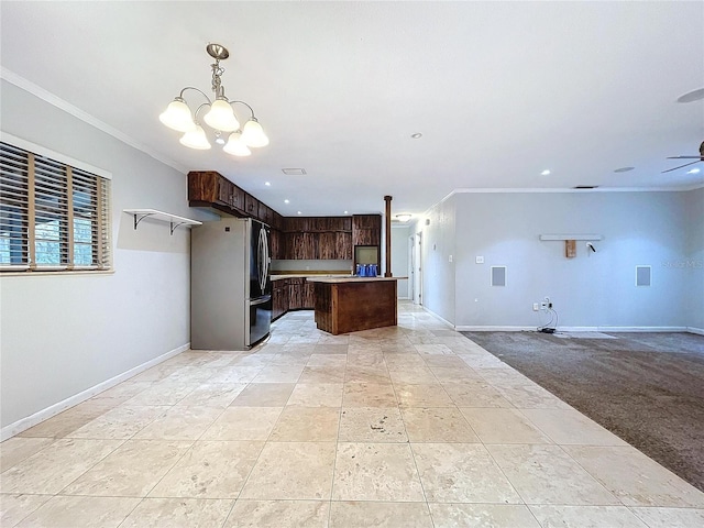 kitchen with crown molding, stainless steel refrigerator, dark brown cabinetry, ceiling fan with notable chandelier, and light colored carpet