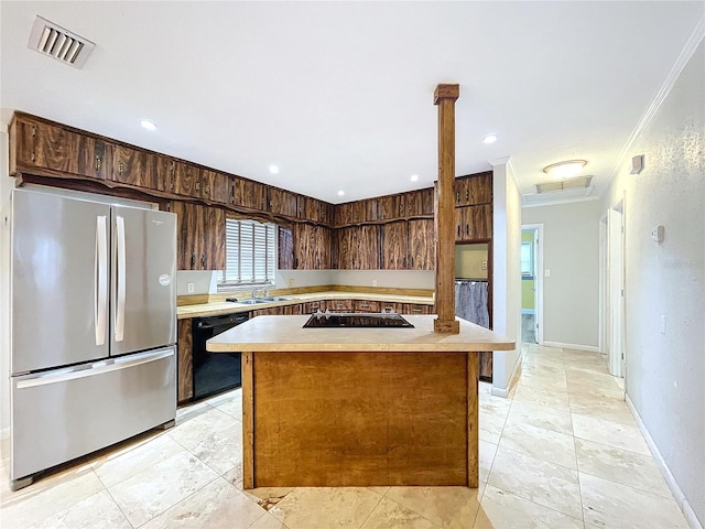 kitchen featuring dark brown cabinetry, sink, crown molding, a center island, and black appliances