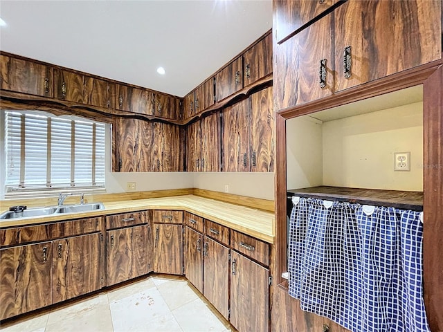 kitchen with dark brown cabinetry and sink