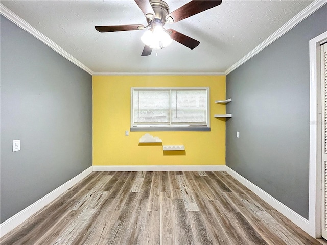 spare room featuring crown molding, hardwood / wood-style floors, ceiling fan, and a textured ceiling