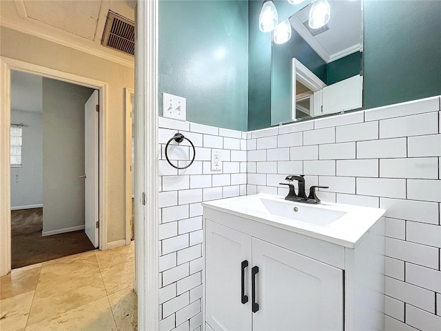 bathroom with crown molding, vanity, and tile walls