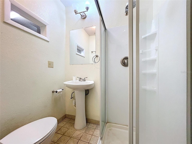 bathroom with tile patterned flooring, an enclosed shower, and toilet