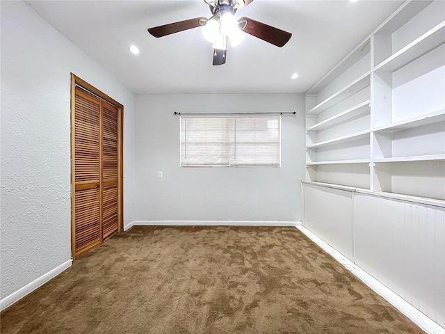 unfurnished bedroom featuring dark carpet, a closet, and ceiling fan