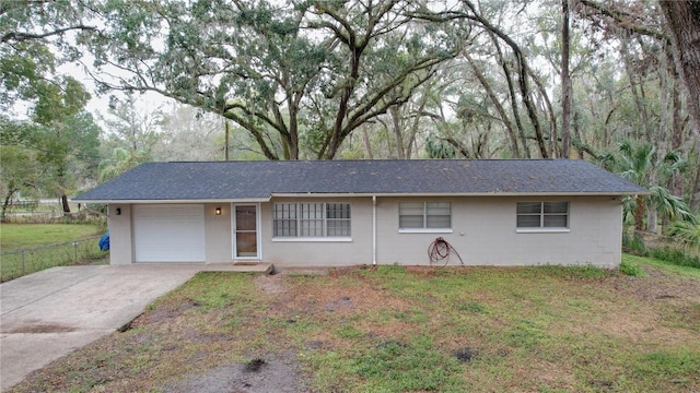 single story home with a garage and a front lawn