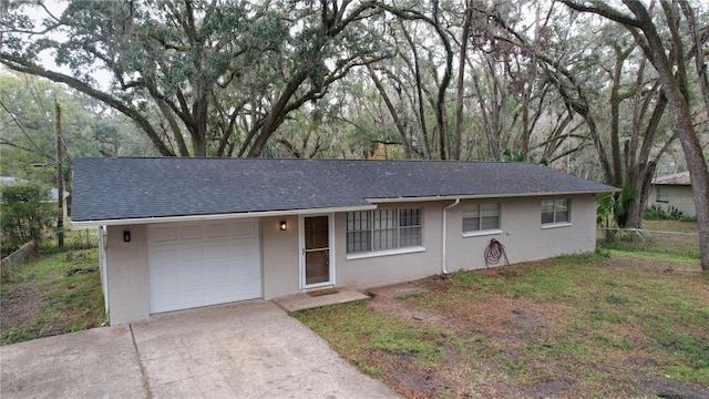 ranch-style house with a garage and a front yard