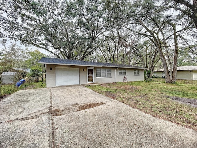 ranch-style house with a garage and a front yard