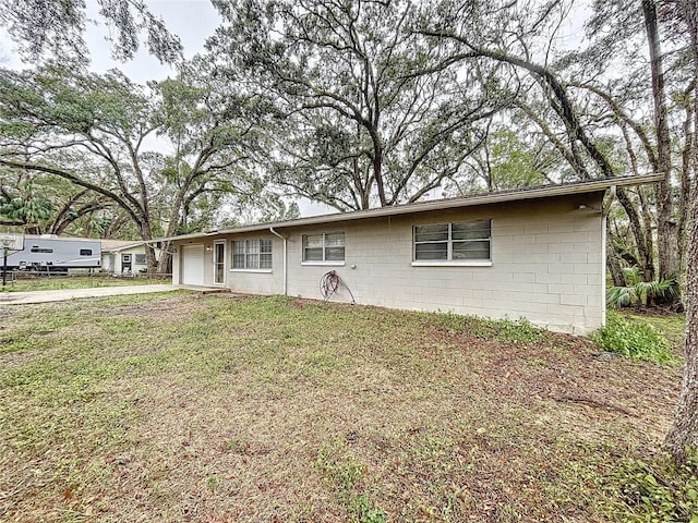 ranch-style house featuring a garage and a front yard