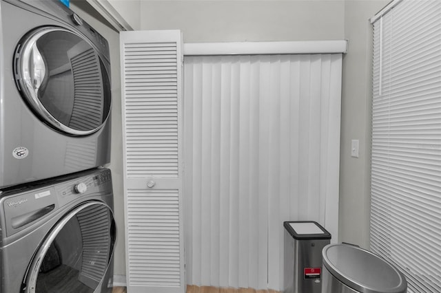 clothes washing area featuring stacked washer / drying machine