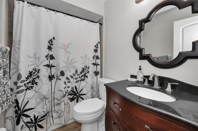 bathroom featuring vanity, toilet, and hardwood / wood-style floors