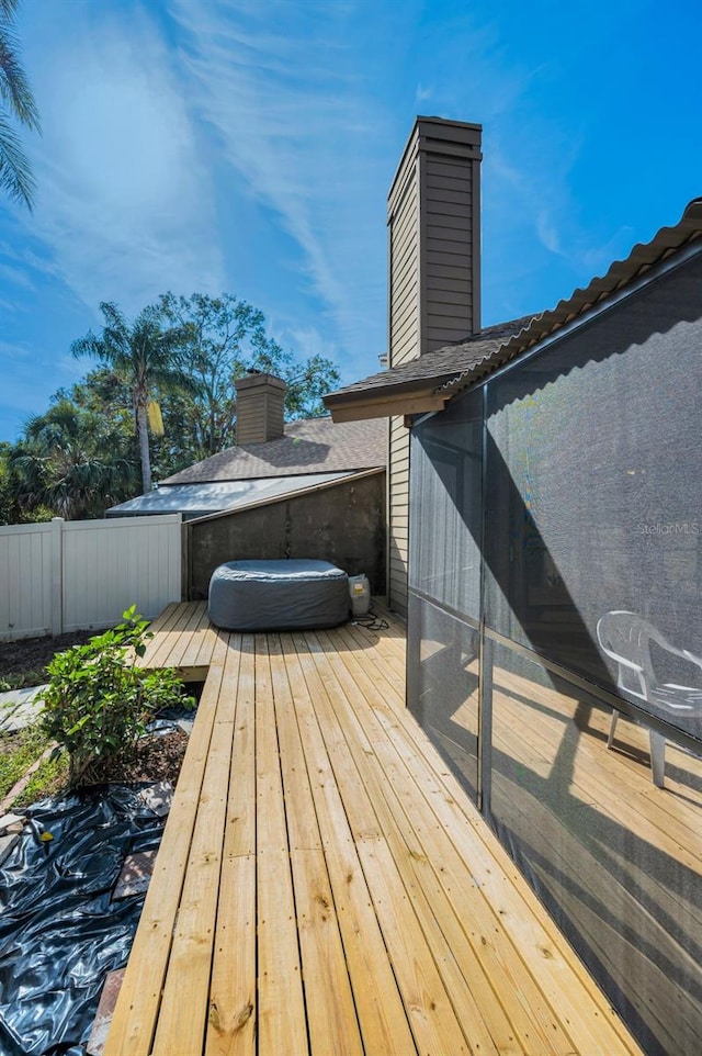 wooden terrace featuring a hot tub