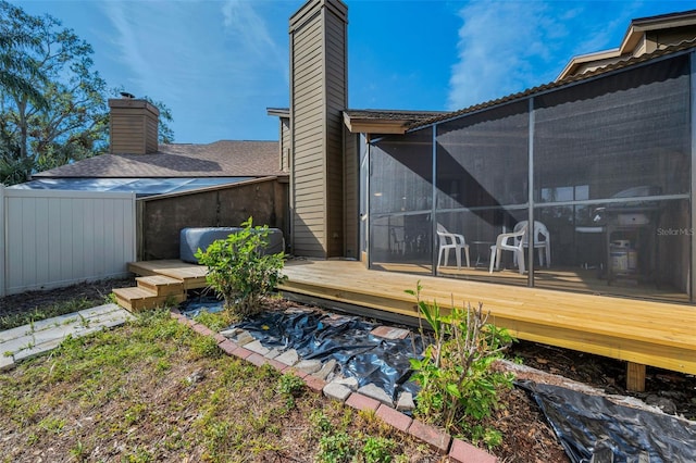 view of yard featuring a sunroom and a wooden deck