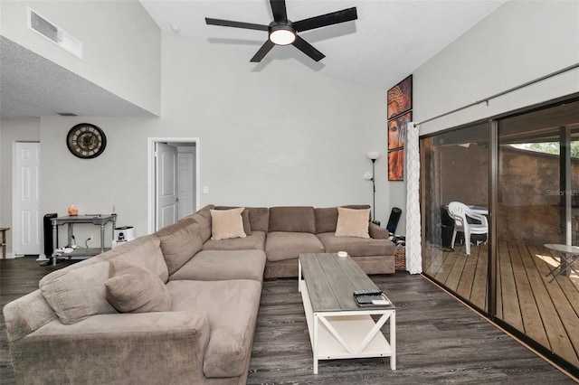 living room with dark hardwood / wood-style flooring, ceiling fan, and high vaulted ceiling