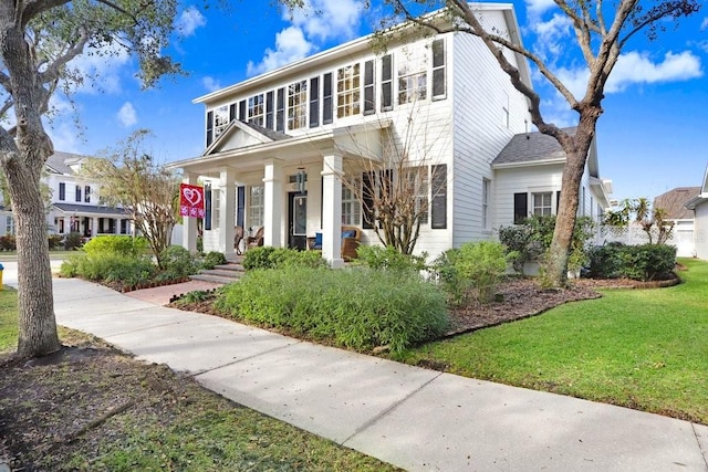 view of front of house featuring a porch and a front lawn