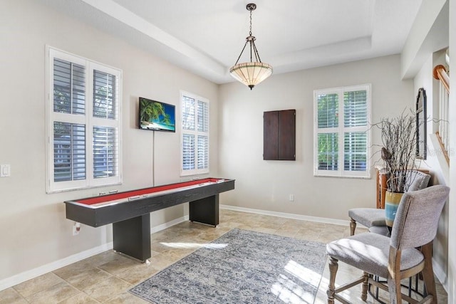 game room featuring a healthy amount of sunlight and a tray ceiling