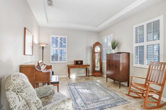 sitting room featuring a raised ceiling