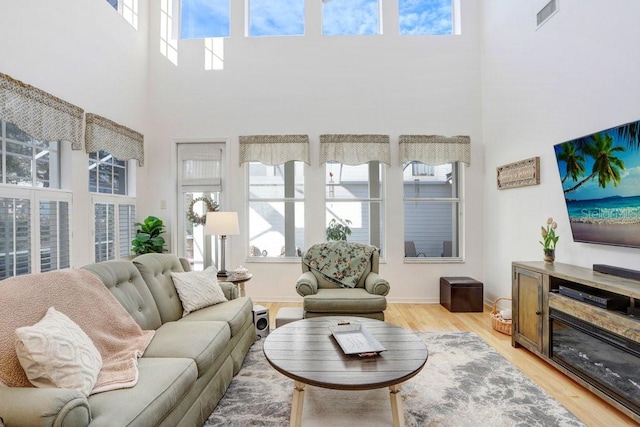 living room featuring plenty of natural light and light hardwood / wood-style floors