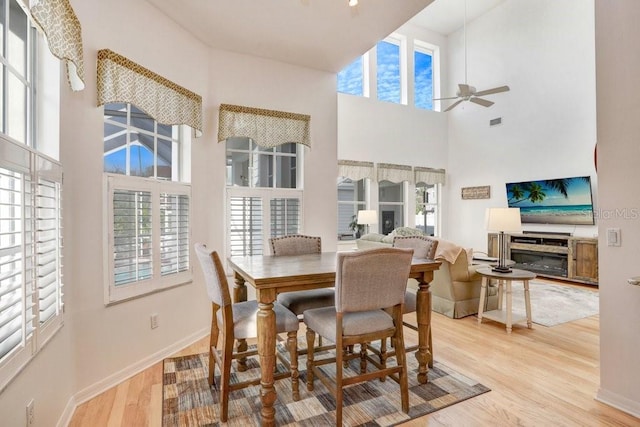 dining area with ceiling fan and light wood-type flooring