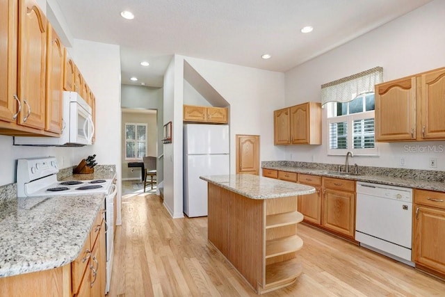 kitchen with sink, a center island, white appliances, light stone countertops, and light hardwood / wood-style floors