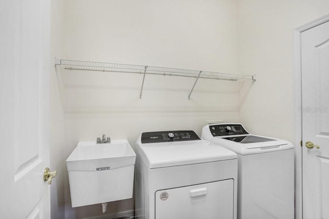 washroom with sink and washer and dryer