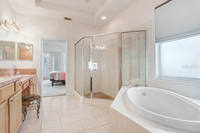 bathroom featuring tile patterned flooring, vanity, a tray ceiling, and plus walk in shower