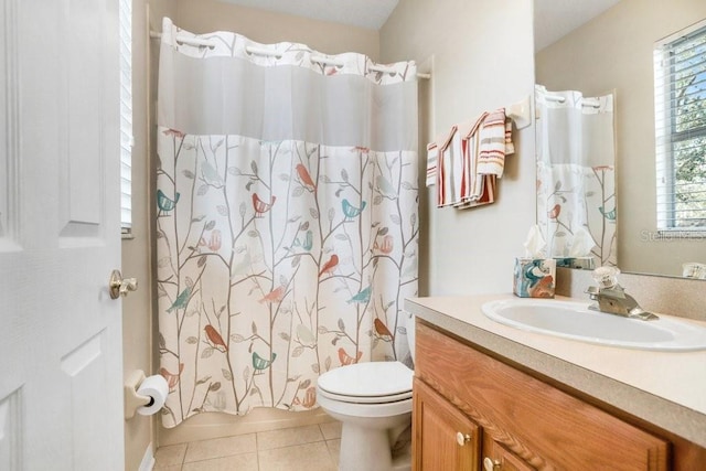 full bathroom featuring shower / tub combo with curtain, tile patterned floors, toilet, and vanity