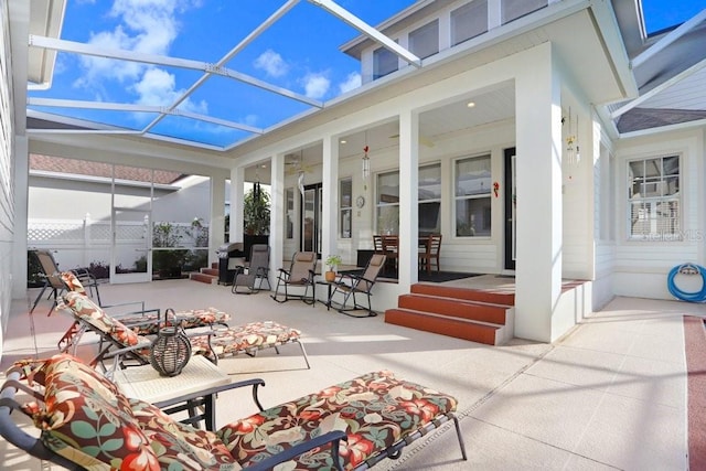 view of patio featuring a lanai