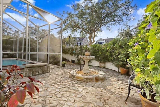 view of patio / terrace featuring glass enclosure