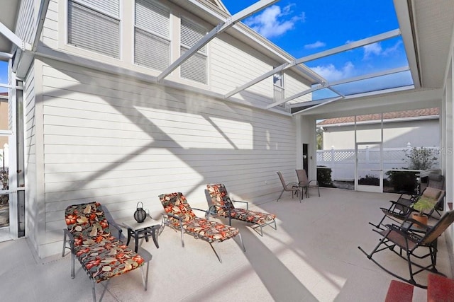 view of patio featuring a lanai