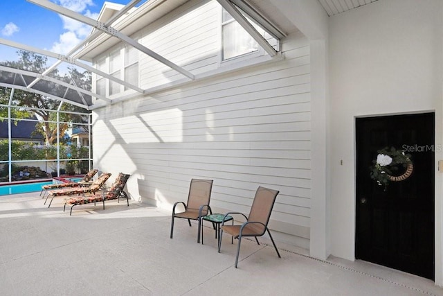 view of patio featuring a lanai