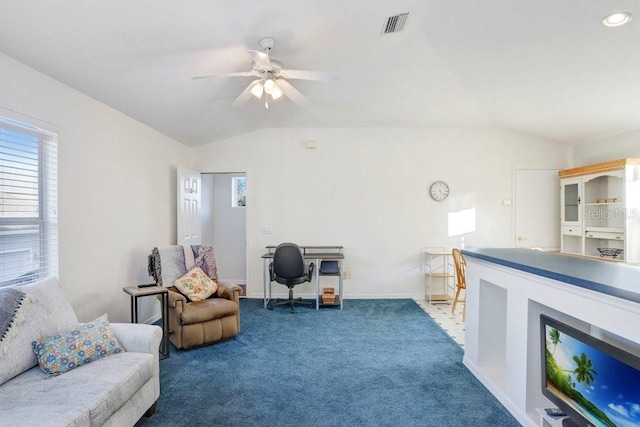 living area with ceiling fan, vaulted ceiling, and carpet